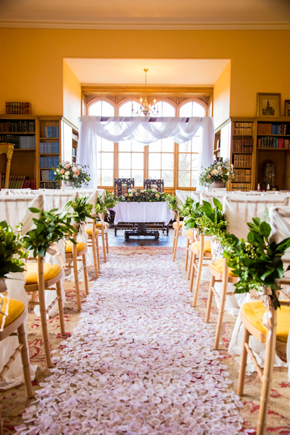 Rose petals covering wedding aisle in the Library, at Delapre Abbey.