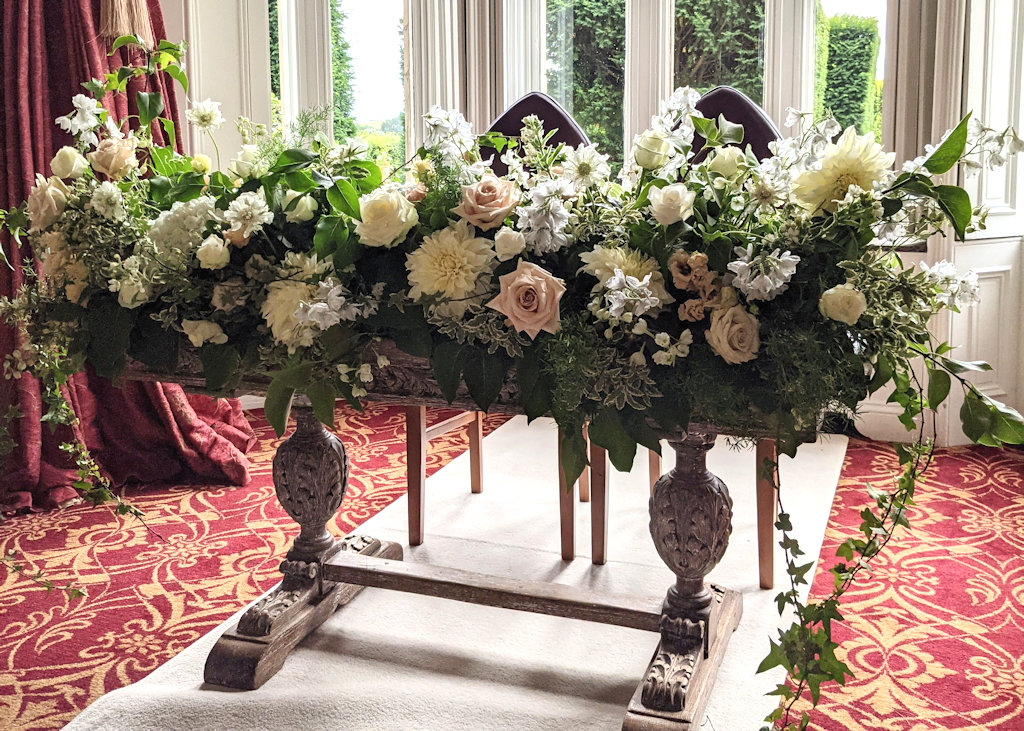 Ceremony Table dressed with country garden flowers. Fawsley Hall, Daventry, Northamptonshire.