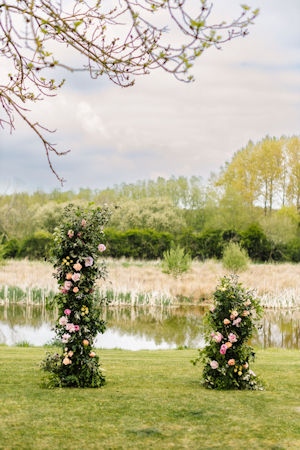 Wedding ceremony floral columns. Outside at The Willow Marsh Farm, Leicestershire. 